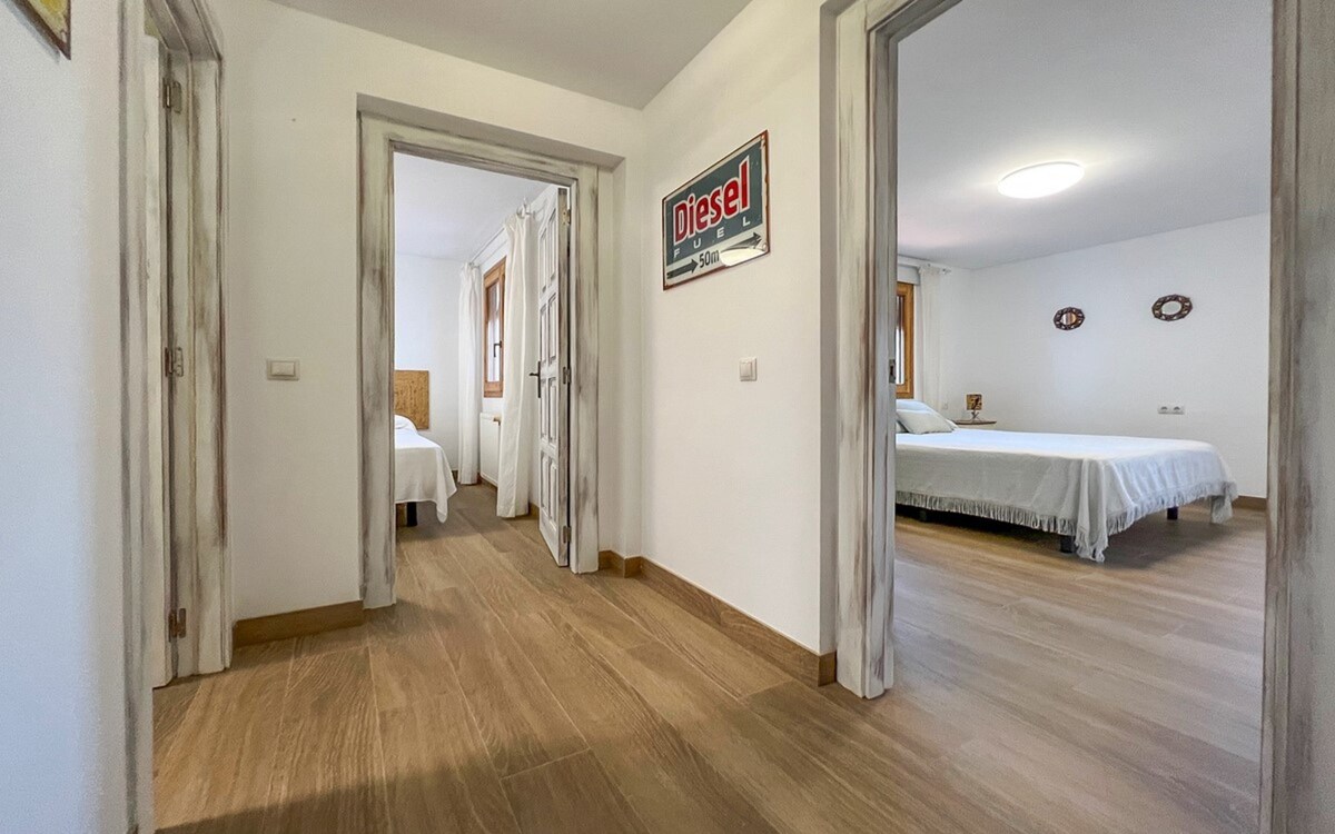 A bright hallway, light from the terrace doors